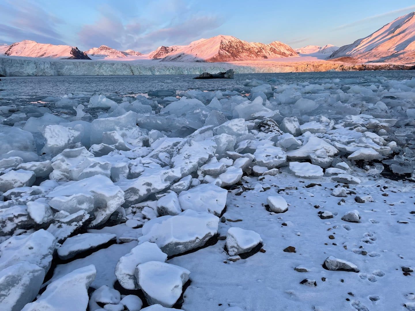 a snowy landscape with mountains and ice